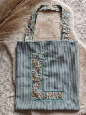 Maison bichette vous propose le tote-bag Aurore. Un tote bag avec une lettre à personnaliser en broderie. Il est cousu dans un velours côtelé et dans un tissu fantaisie en coton